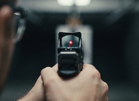 Man using a red dot at a firing range