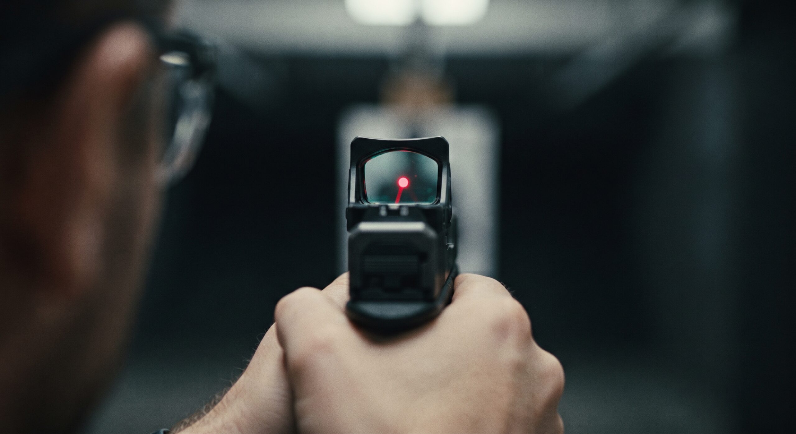 Man using a red dot at a firing range